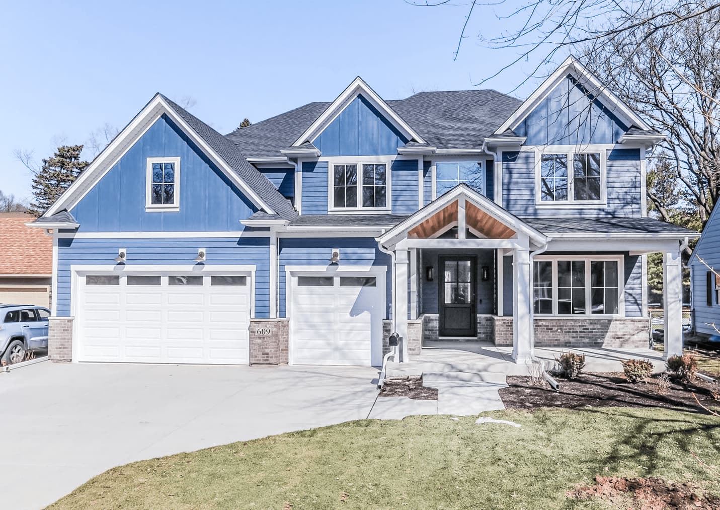 CHI raised panel garage door on blue craftsman home